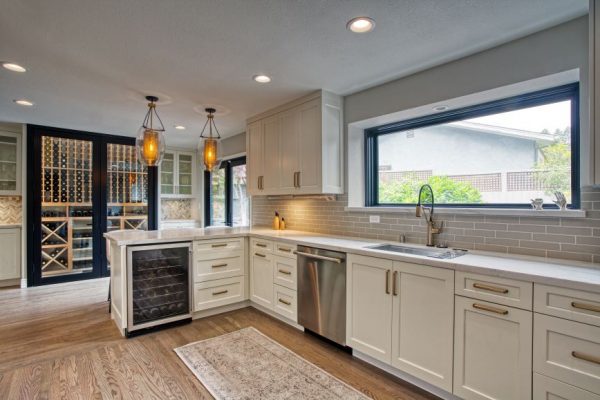 This amazing kitchen is featuring Bellmont 1900 cabinetry with hardware Top knobs. Faucet by Brizo Artesso collection. Backsplash by Sonoma Tile Makers and Akdo.