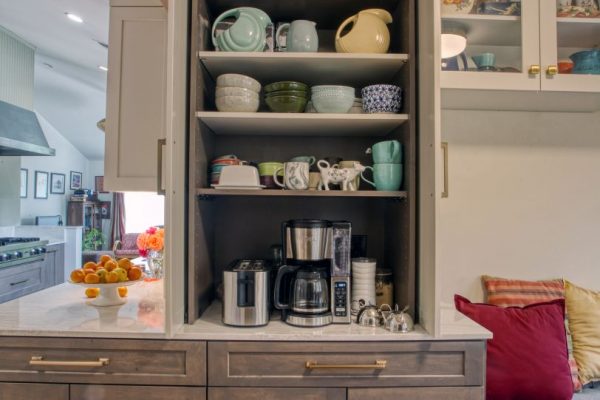 Contemporary Kitchen Cabinets by Wood-Mode Bi-Tone Matte carbon in maple and white painted. Larder cabinet with hideaway doors for extra storage and coffee station. Hardware Belwith Keeler warm champagne. Backsplash Akdo origami white haze marble. Countertop Cambria quartz. Le grand radiant plates.
